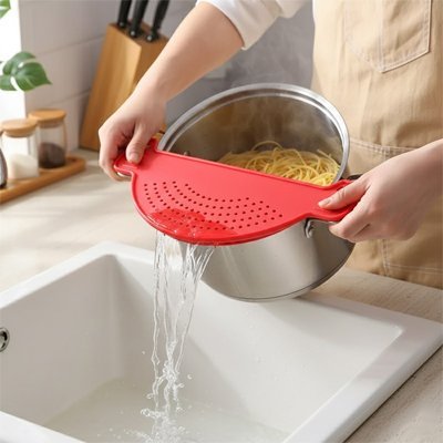 passoire rouge avec casserole de spaghetti vidant eau