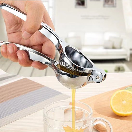 presse agrume dans tasse en verre cuisine blanche gros plan