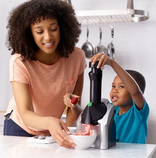 sorbetiere femme avec garcon faisant un sorbet aux fraises